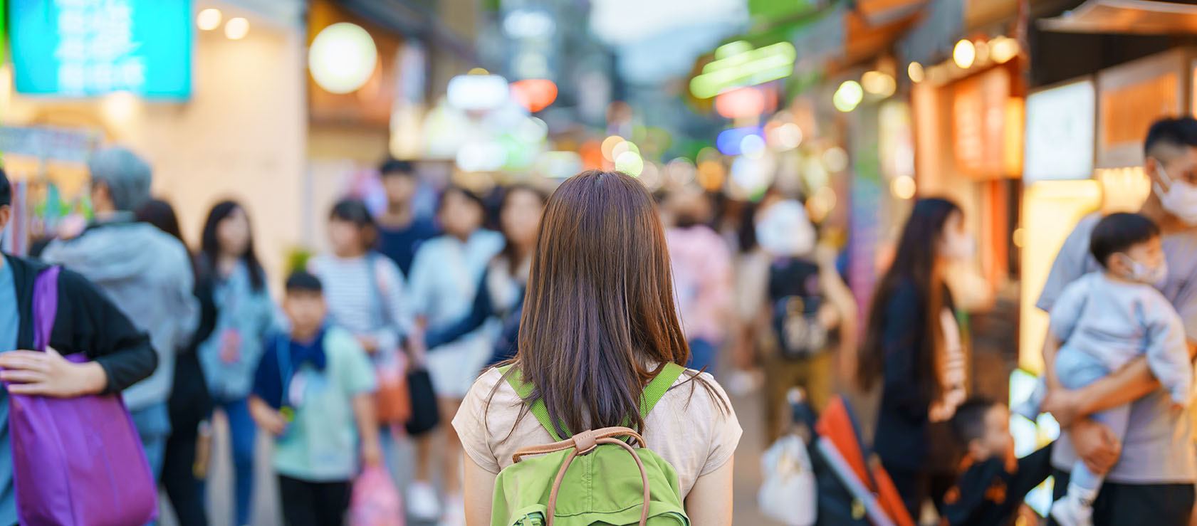 woman traveler visiting a busy street with lights
